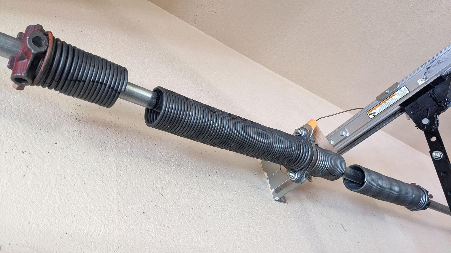 Broken garage door spring, garage door won’t open, garage door make a load banging noise 